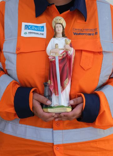 Santa Barbara (patron saint of travellers) is blessed before being placed alongside a shaft